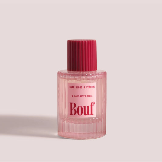 A bottle of Bouf Hair Gloss & Perfume in the scent, A Lady Never Tells, against a solid light beige background.