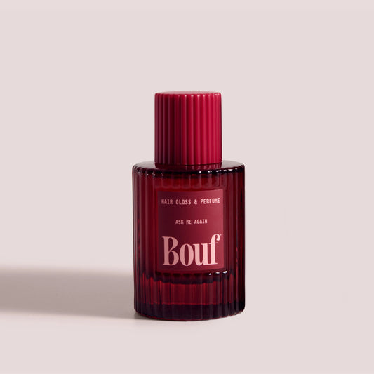 A bottle of Bouf Hair Gloss & Perfume in the scent Ask Me Again against a solid grey background.
