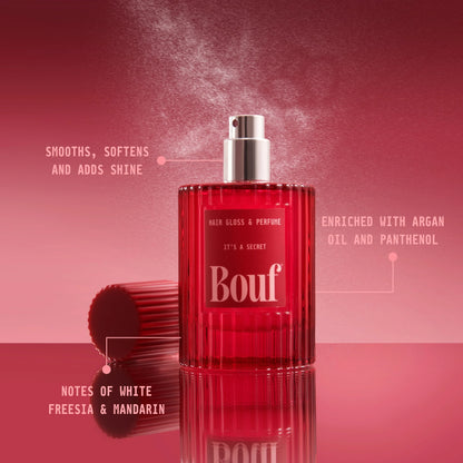 A red ribbed glass bottle of Bouf Hair Gloss & Perfume centered on a pink-red gradient background with callout text describing its benefits and scent notes.