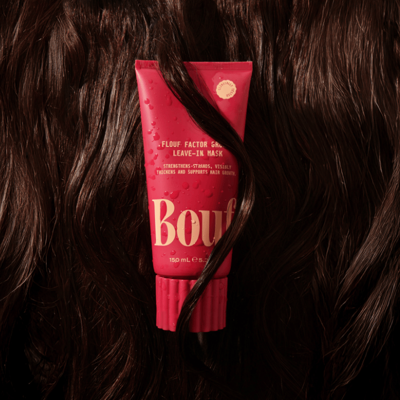 Red hair mask tube with 'Bouf' branding on dark hair